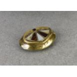 A 19th century brass snuff box of scallop shaped form, engraved with a foliate design, the lid