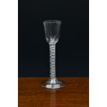 A mid-18th century airtwist wine glass, c.1750-60, the pointed round funnel bowl on a double