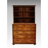 An early 19th century mahogany secretaire bookcase, the matched open bookcase top over a straight