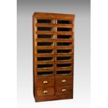 A mid-century oak haberdashery cabinet, the stepped, Art Deco style top over two banks of eight