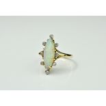 A vintage 18ct gold, opal and diamond cluster ring, the elliptical opal displaying predominantly