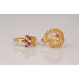 Two 18ct yellow gold and ruby rings (2), one an ornate basket bombe design with a single round cut