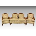 A 1930s three piece walnut bergère suite, of small proportions, comprising a two seater settee and