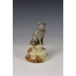 An Elizabeth II silver seated cat on alabaster socle base, Mappin & Webb, Birmingham, 1994, the