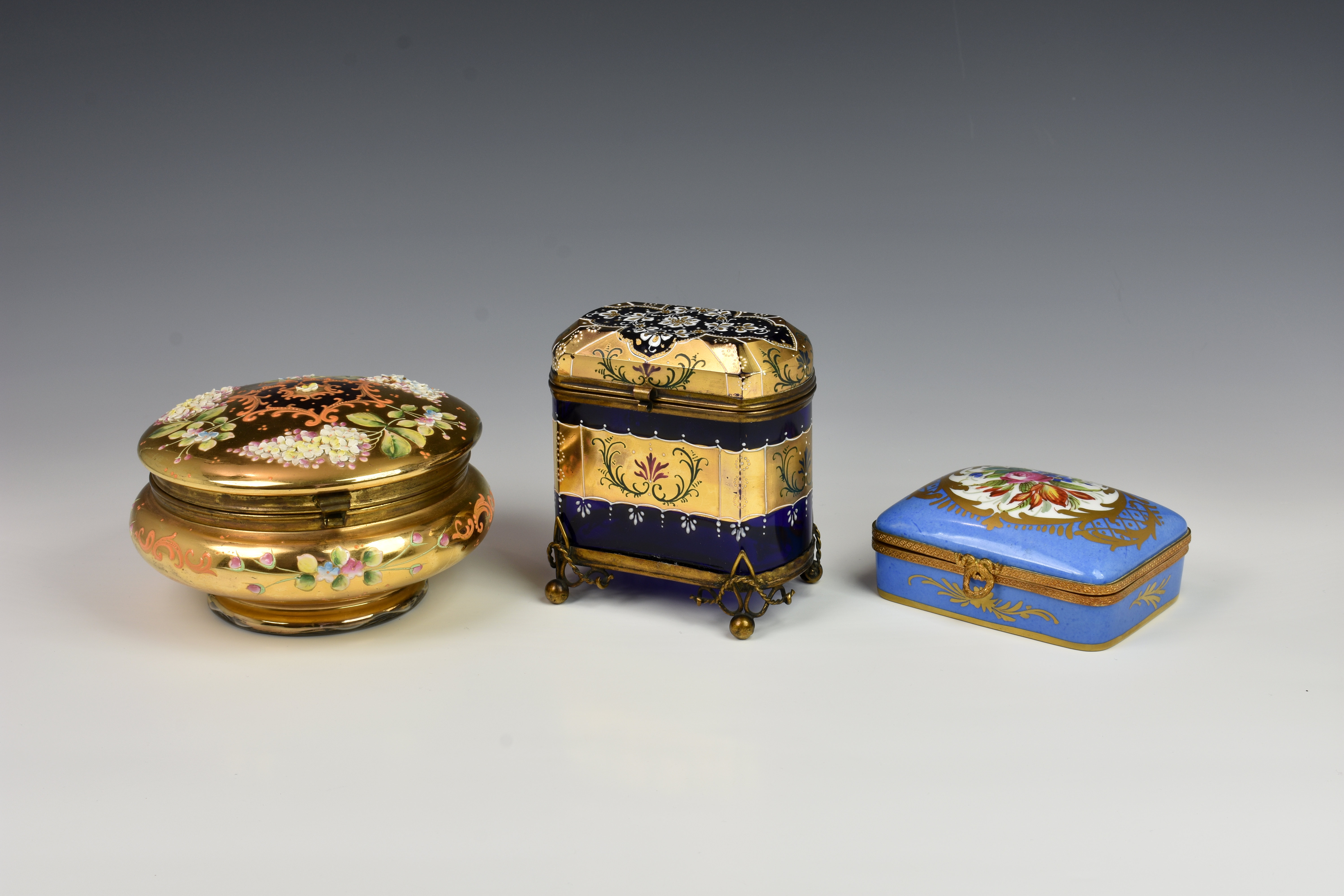 A French porcelain and gilt metal box, 20th century, painted with a floral reserve with gilt