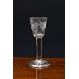 A mid-18th century engraved wine glass, c.1750, the funnel bowl engraved with a fruiting vine and