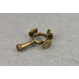 A polished bronze finger ring cruciform cigar tamper and seal combination, probably late 18th