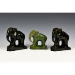 A pair of black Art Deco cubist style pottery elephants, on plinth bases, standing 7½in. (19cm.)