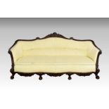 A late Victorian carved mahogany showframe settee, the serpentine back with foliate, cabochon and