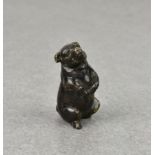 A miniature patinated bronze seated pig, probably early 20th century, the seated pig with a very