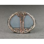 An Art Nouveau miniature twin section photo frame, silver plate on copper, of oval form, decorated