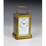 A gilt brass carriage clock, early 20th century, corniche case, white enamel Roman dial, signed by