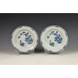 A closely matched pair of late 18th century Chinese export soup bowls, painted in blue and white