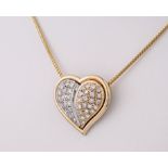 An 18ct yellow and white gold heart shaped pendant, inset with brilliant cut diamonds totalling