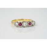 An 18ct yellow gold, diamond and ruby 5 stone ring, with 3 brilliant cut diamonds and 2 round cut