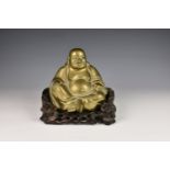 A Chinese bronze figure of Buddha, probably early 20th century, modelled seated with a laughing