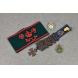 An original Woman's Land Army armband and badge, together with a Women's Land Army and Timber