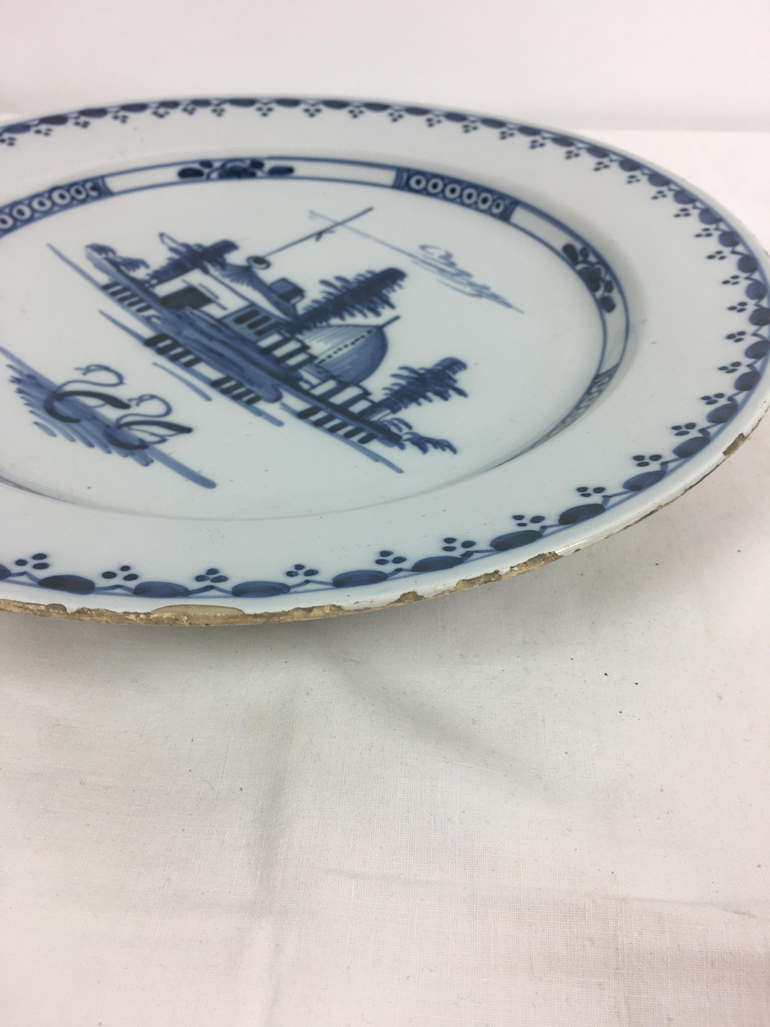 A Delft blue and white charger, the centre decorated with houses and a pair of swans, 13¼in. (33. - Image 8 of 9