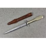 A 1930's German fighting knife, having metal shaped handle, the blade 6 5/8in. (17cm.) long, leather