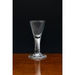 A mid-18th century small airtwist wine glass, c.1760-70, with drawn conical bowl and multi spiral