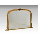 A Victorian style gilt and composition overmantel mirror, the arched plate within a gadrooned