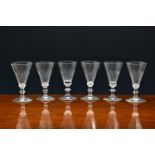 A closely matched set of six early Victorian sherry or port glasses, the trumpet bowls with petal