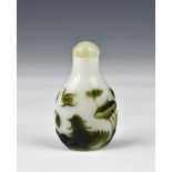 A Chinese carved cameo glass snuff bottle, of flattened pear form, the dark spinach green and