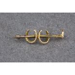 Horse riding interest - a vintage 9ct gold stick pin, in the form of a riding crop and two