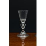 A good early baluster wine glass with acorn knop, c.1700, the conical bowl with solid base, on an