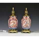 A pair of Japanese porcelain Imari vase lamps, late 19th century, the tapered, fluted ovoid form
