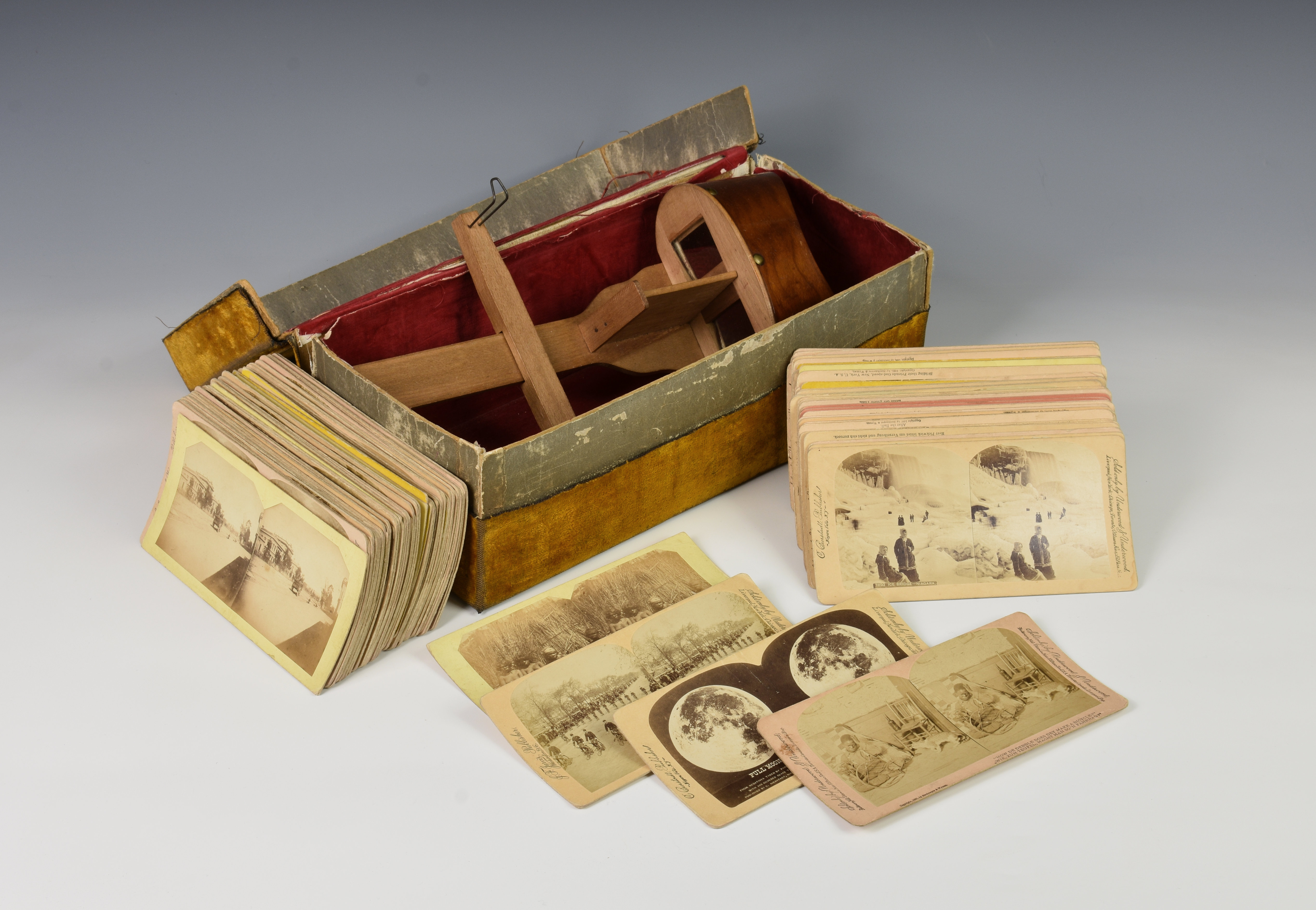 A stereoscopic viewer and quantity of cards, to include many comical scenes comprising of five by