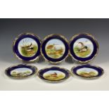 A set of six Spode 'Game Birds' cabinet plates, the hand painted design with blue border and gilt