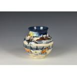 A Moorcroft Woodside Farm pattern baluster vase, dated 1999, decorated with foxes in a snowy