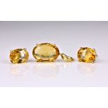 A 14ct yellow gold and citrine pendant and stud earrings en suite, with oval cut citrines, the