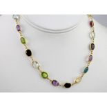 A multicoloured stone necklace, earring and bracelet suite, featuring oval, pear and emerald cut
