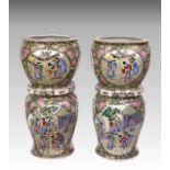 A pair of Chinese porcelain fish bowls on stands, 20th century, the bowls painted in the famille