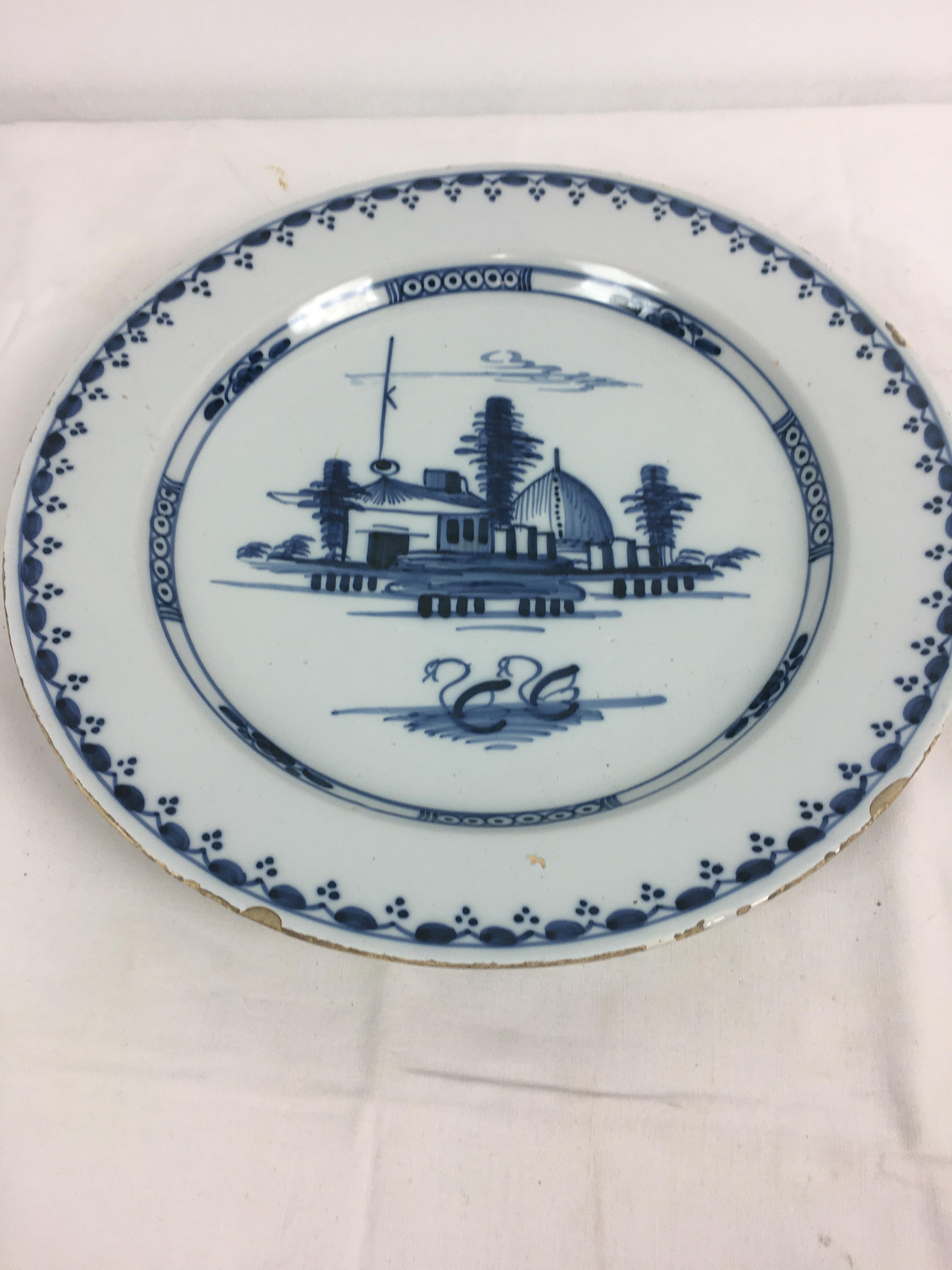 A Delft blue and white charger, the centre decorated with houses and a pair of swans, 13¼in. (33. - Image 6 of 9