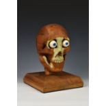 An unusual 20th century carved pine medical / anatomical skeleton skull, sectional pine construction