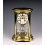 A French oval gilt brass four glass mantel clock by J. Marti & Cie, with white Roman enamel