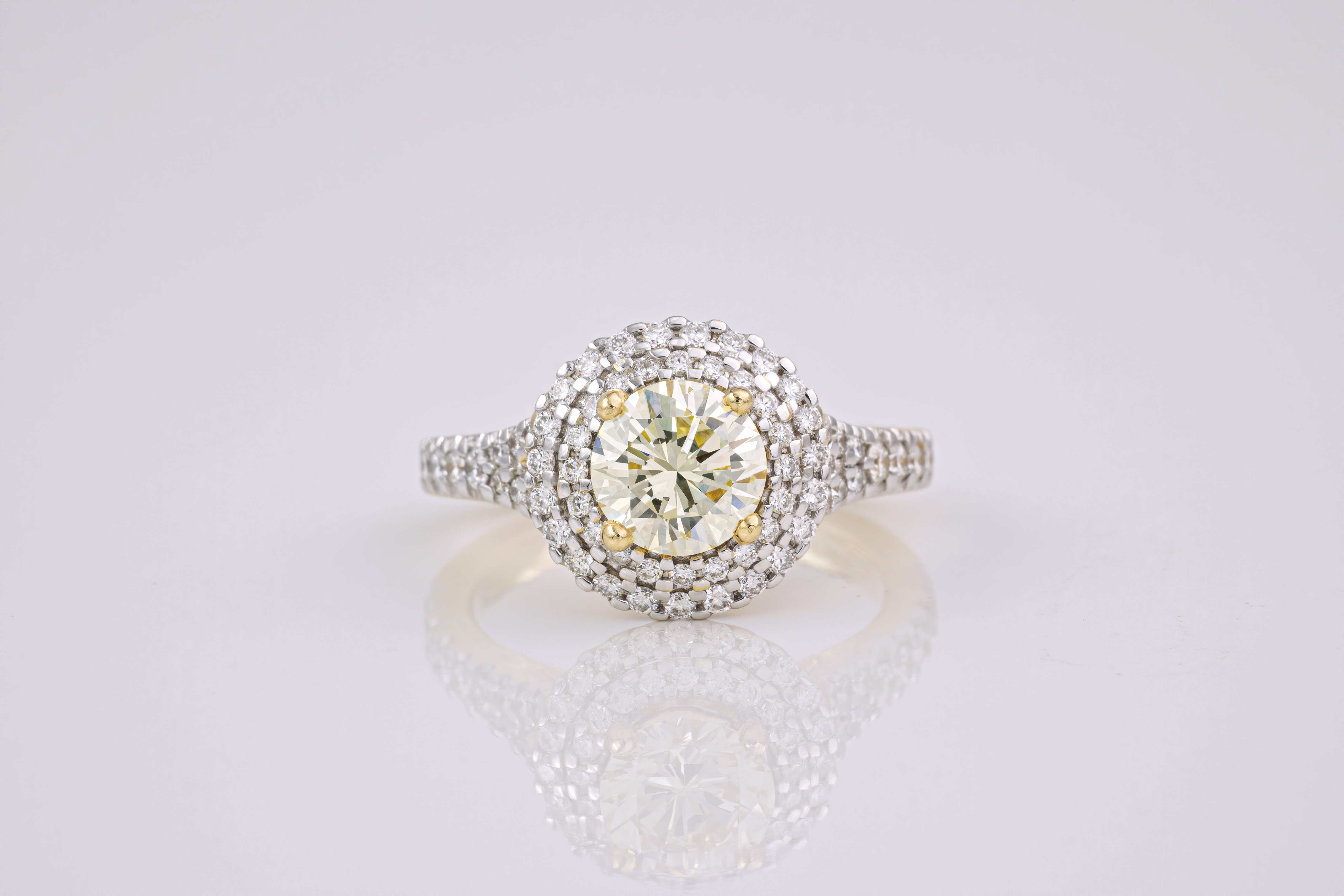 A light yellow diamond and 18ct gold ring, The brilliant cut, light yellow diamond weighing
