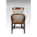 A late Victorian walnut Windsor style chair, the comb back over U-shaped arms on ring turned