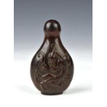 A Chinese carved horn snuff bottle, probably 19th century, of flattened baluster form, carved to