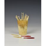 A miniature antique horn beaker with quantity of bone pick up sticks and fish gaming counters