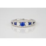 An 18ct white gold, diamond and sapphire ring., Featuring 5 brilliant cut sapphires dispersed