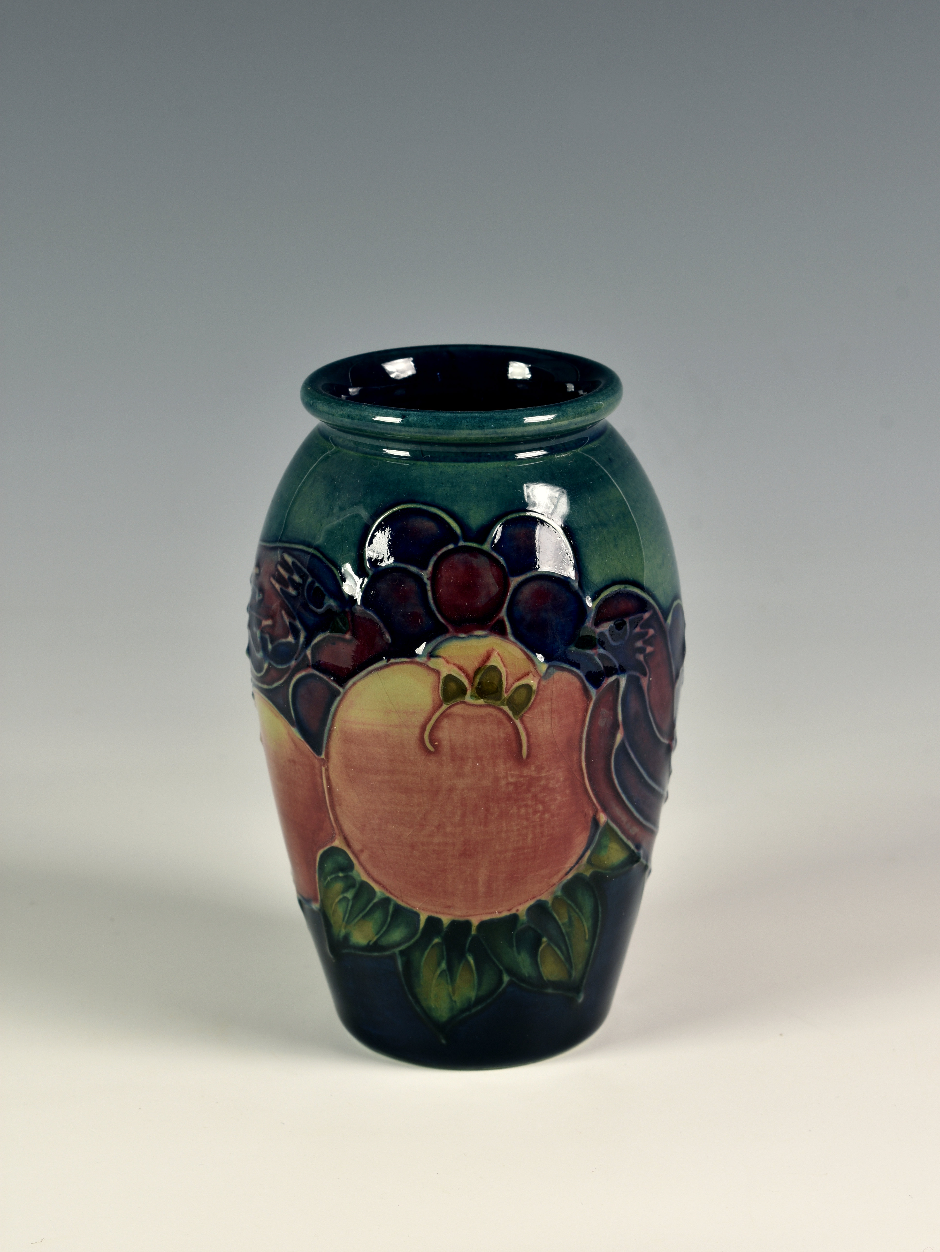 A modern Moorcroft 'Birds and Fruit' vase, the small ovoid vase decorated with birds and fruit on