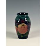 A modern Moorcroft 'Birds and Fruit' vase, the small ovoid vase decorated with birds and fruit on