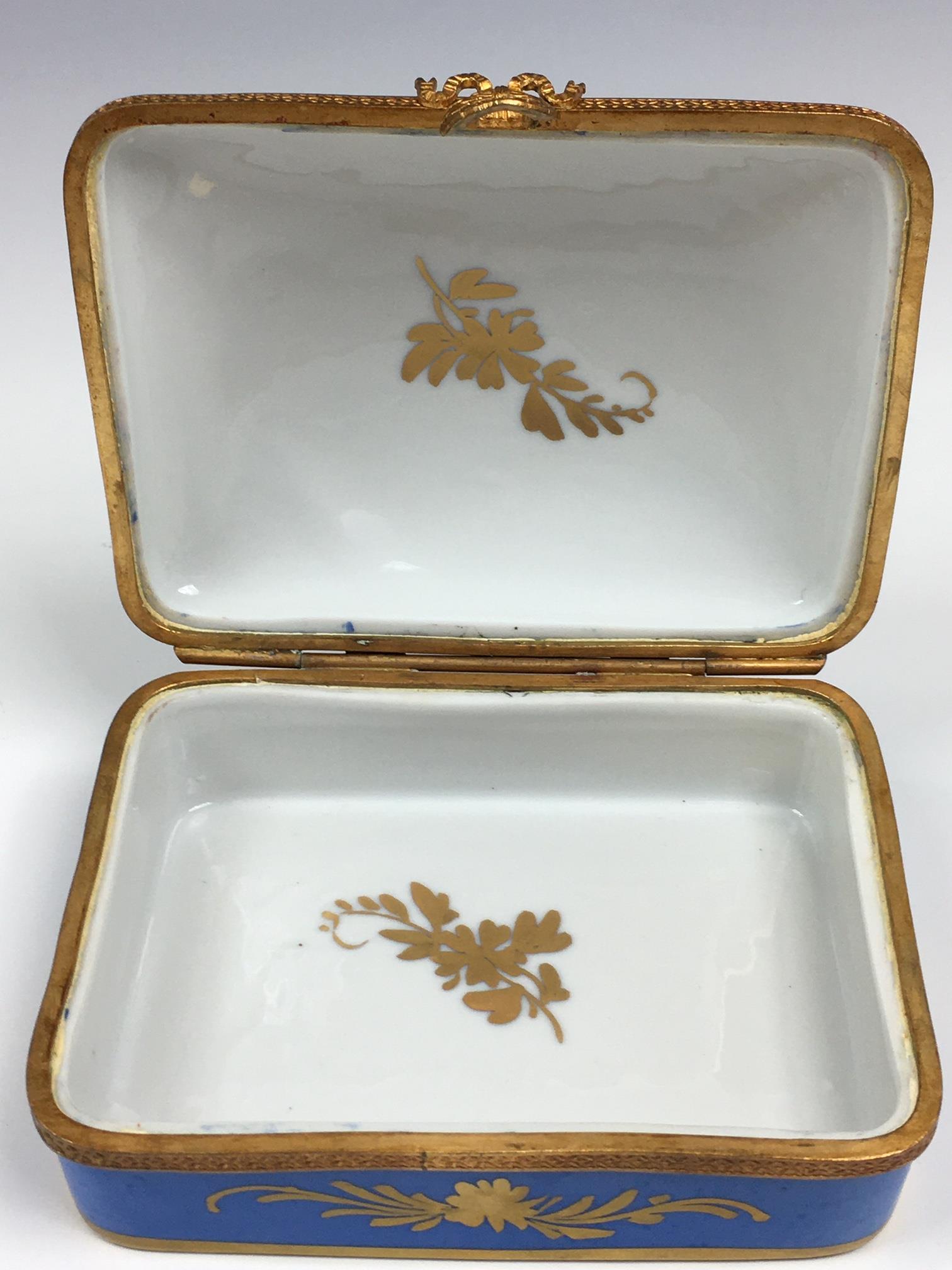A French porcelain and gilt metal box, 20th century, painted with a floral reserve with gilt - Image 19 of 22
