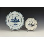 A Delft blue and white charger, the centre decorated with houses and a pair of swans, 13¼in. (33.