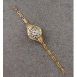 An Art Deco 18ct gold ladies wrist watch, 1930s-40s, the silvered tonneau shaped dial with 'watered'