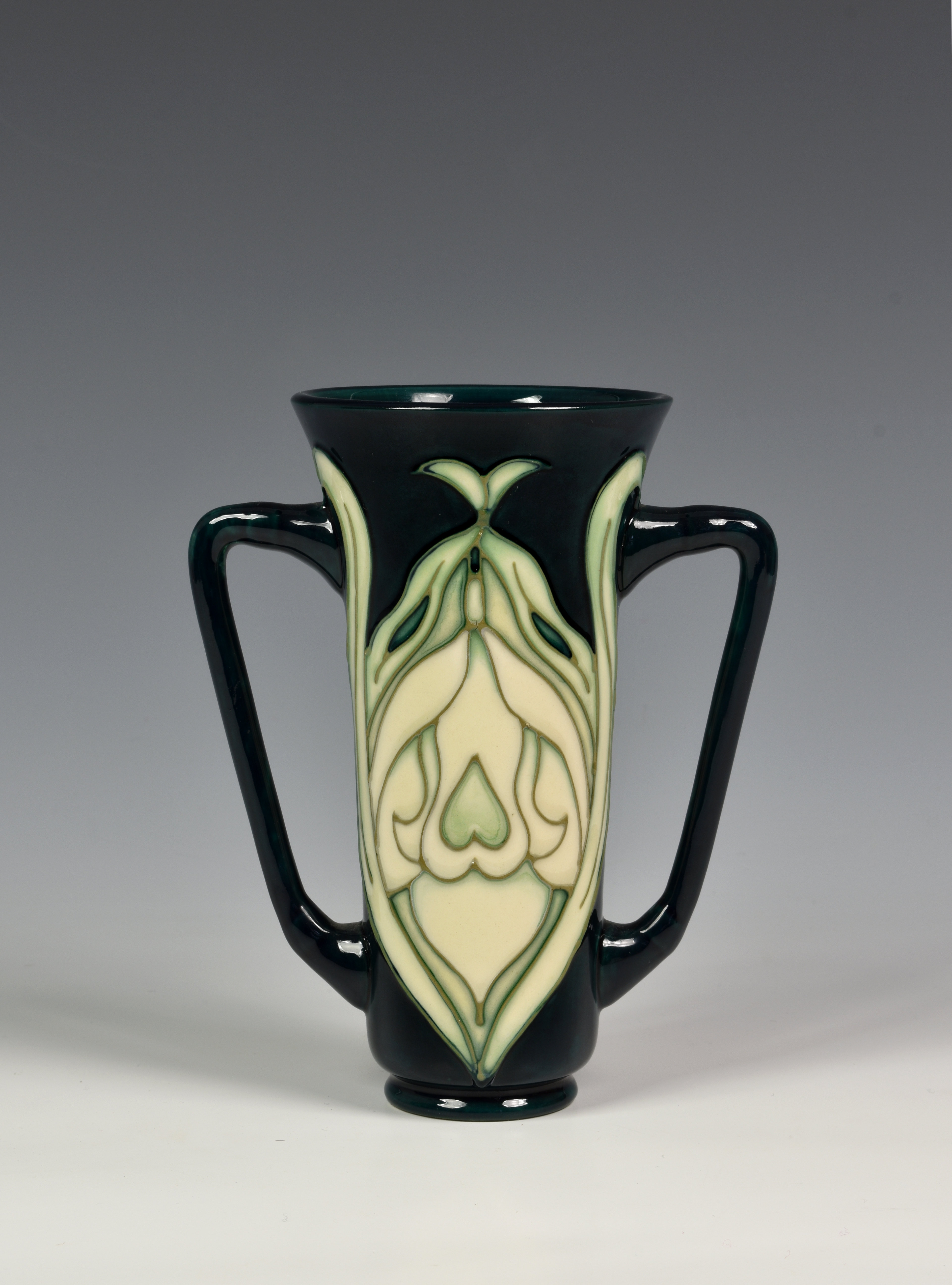 A Moorcroft Pottery twin handled trumpet form 'Snowdrop' pattern vase, Rachel Bishop for Moorcroft